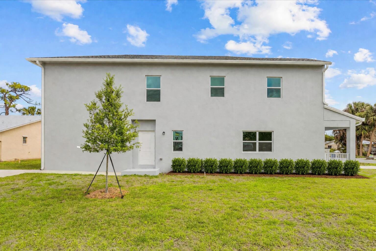 2575 Southeast Bonita Street Stuart, FL 34997 - Photo 3 of 17 a house view with a garden space