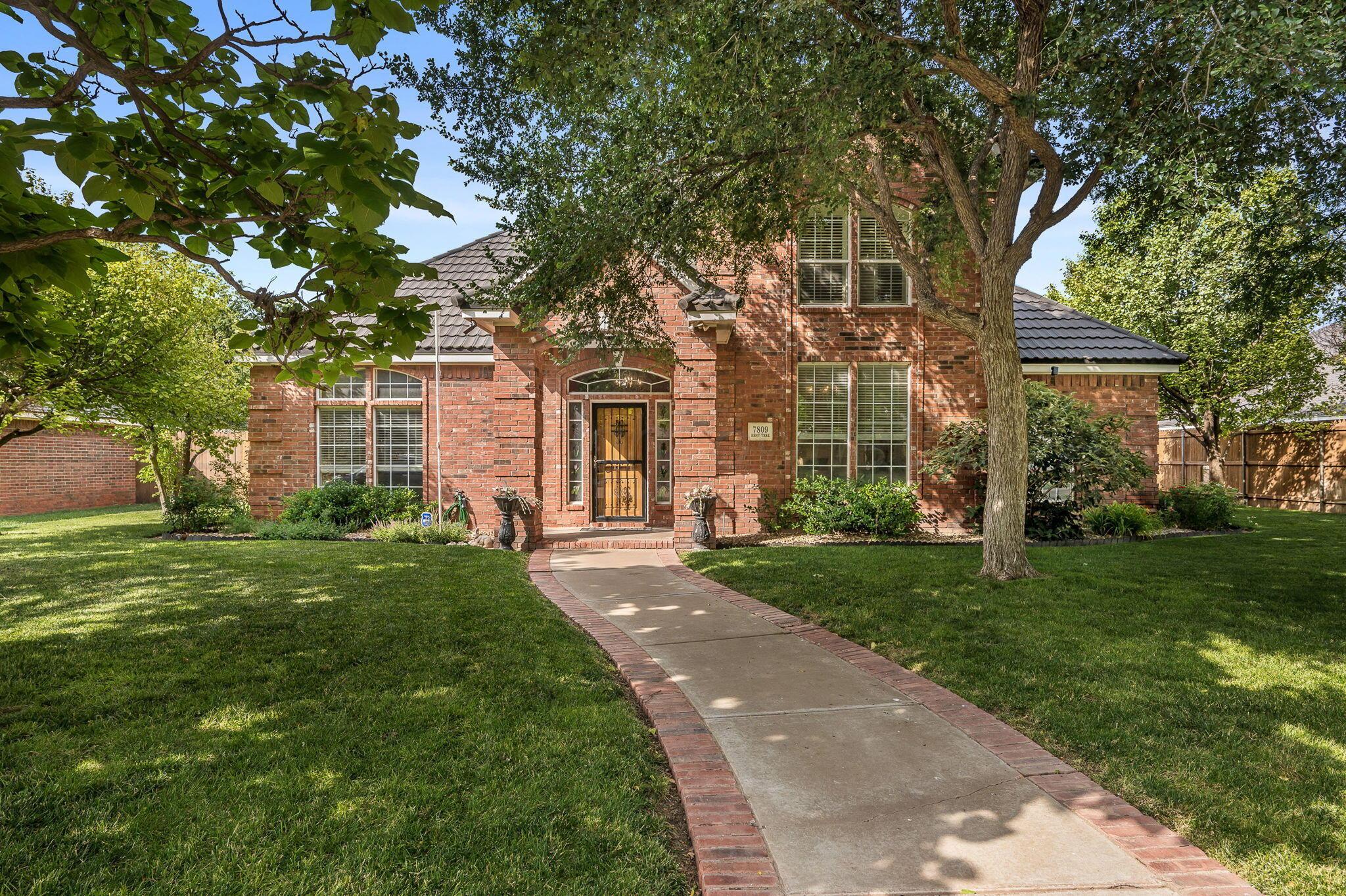 7809 Bent Tree Drive Amarillo, TX 79121 - Photo 1 of 32 front view of a house with a yard