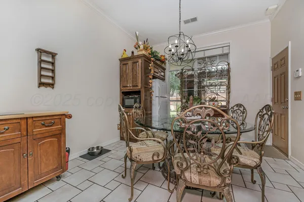 a view of a dining room with furniture and chandelier