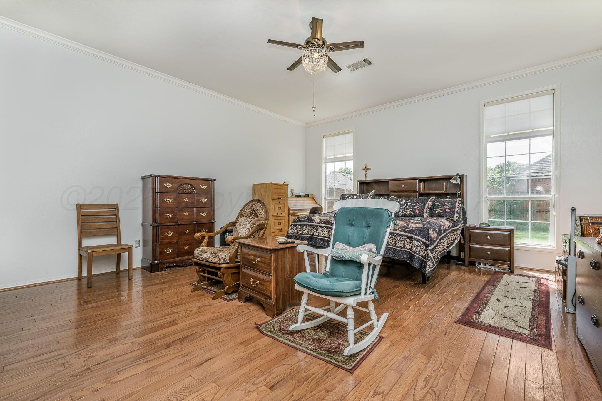7809 Bent Tree Drive Amarillo, TX 79121 - Photo 15 of 32 a living room with furniture and a wooden floor