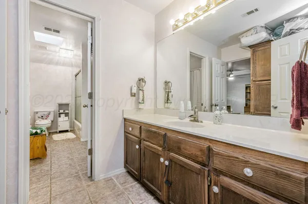 a spacious bathroom with a sink a mirror and a shower