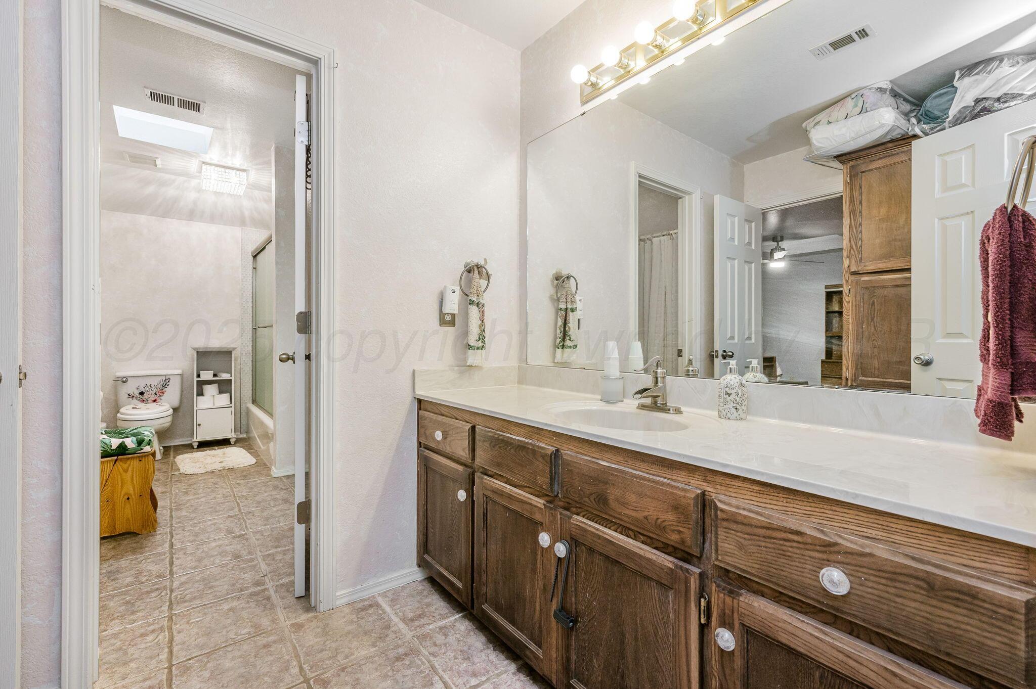 7809 Bent Tree Drive Amarillo, TX 79121 - Photo 24 of 32 a spacious bathroom with a sink a mirror and a shower