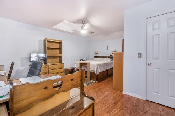 a bedroom with furniture and a ceiling fan