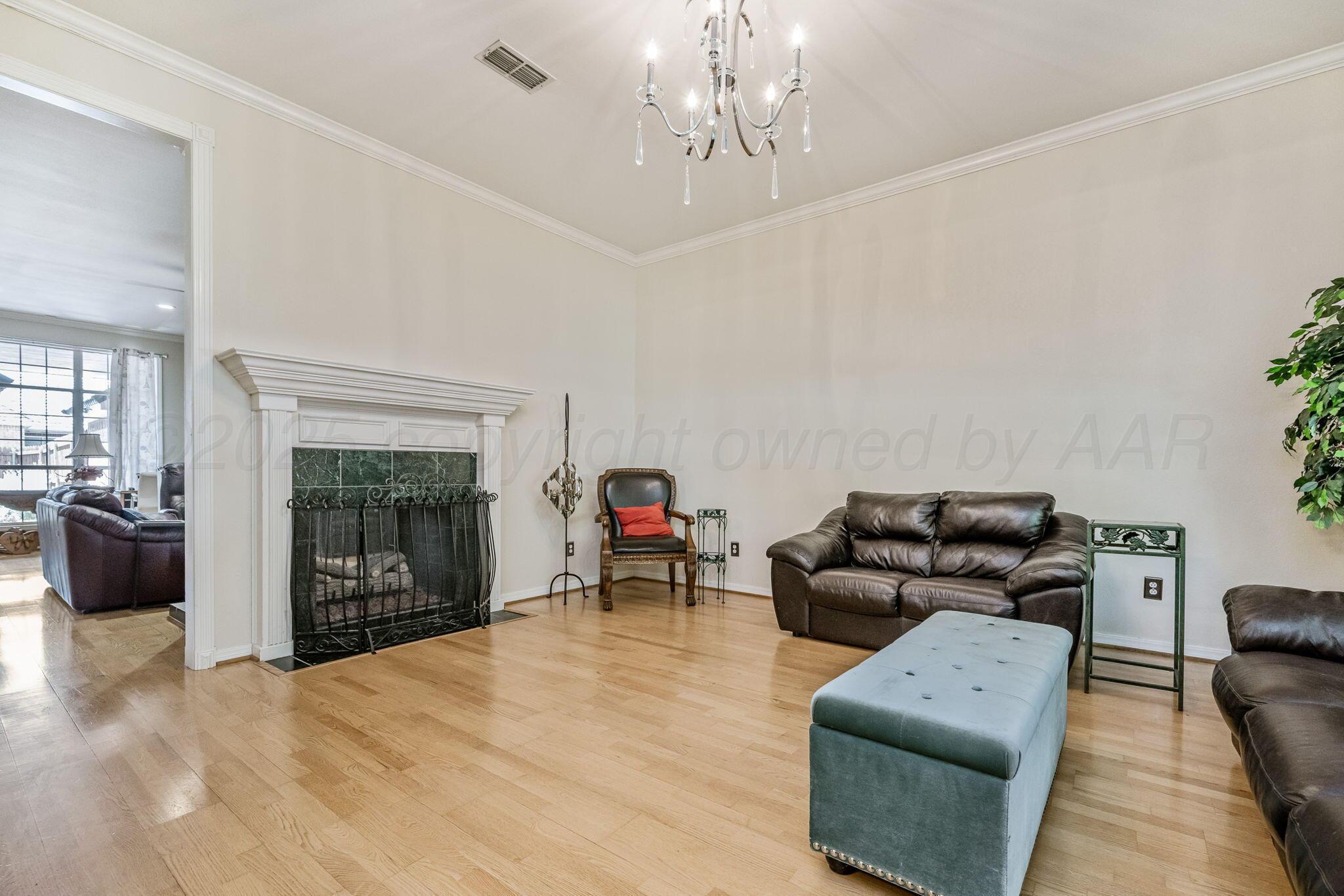 7809 Bent Tree Drive Amarillo, TX 79121 - Photo 6 of 32 a living room with furniture and a fireplace
