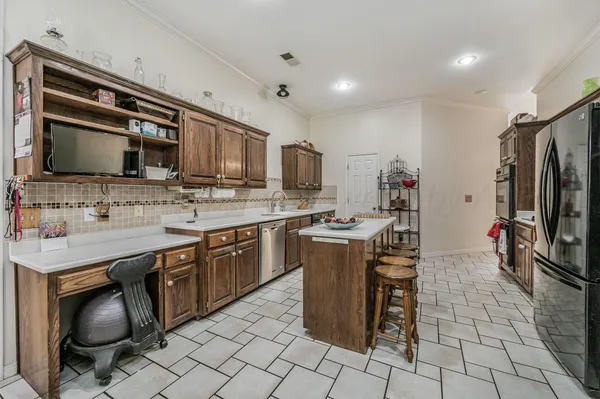 a kitchen with a sink stainless steel appliances and cabinets