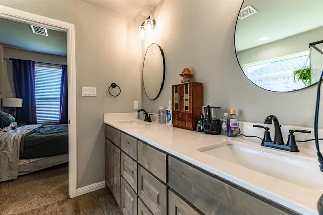 a bathroom with a sink mirror and window