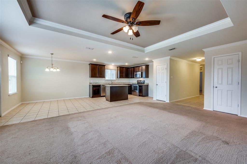 1420 Rivers Creek Lane Little Elm, TX 75068 - Photo 5 of 25 a view of a livingroom with a ceiling fan and a kitchen