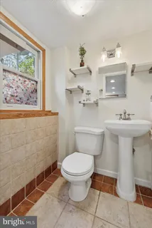 a bathroom with a sink mirror and toilet