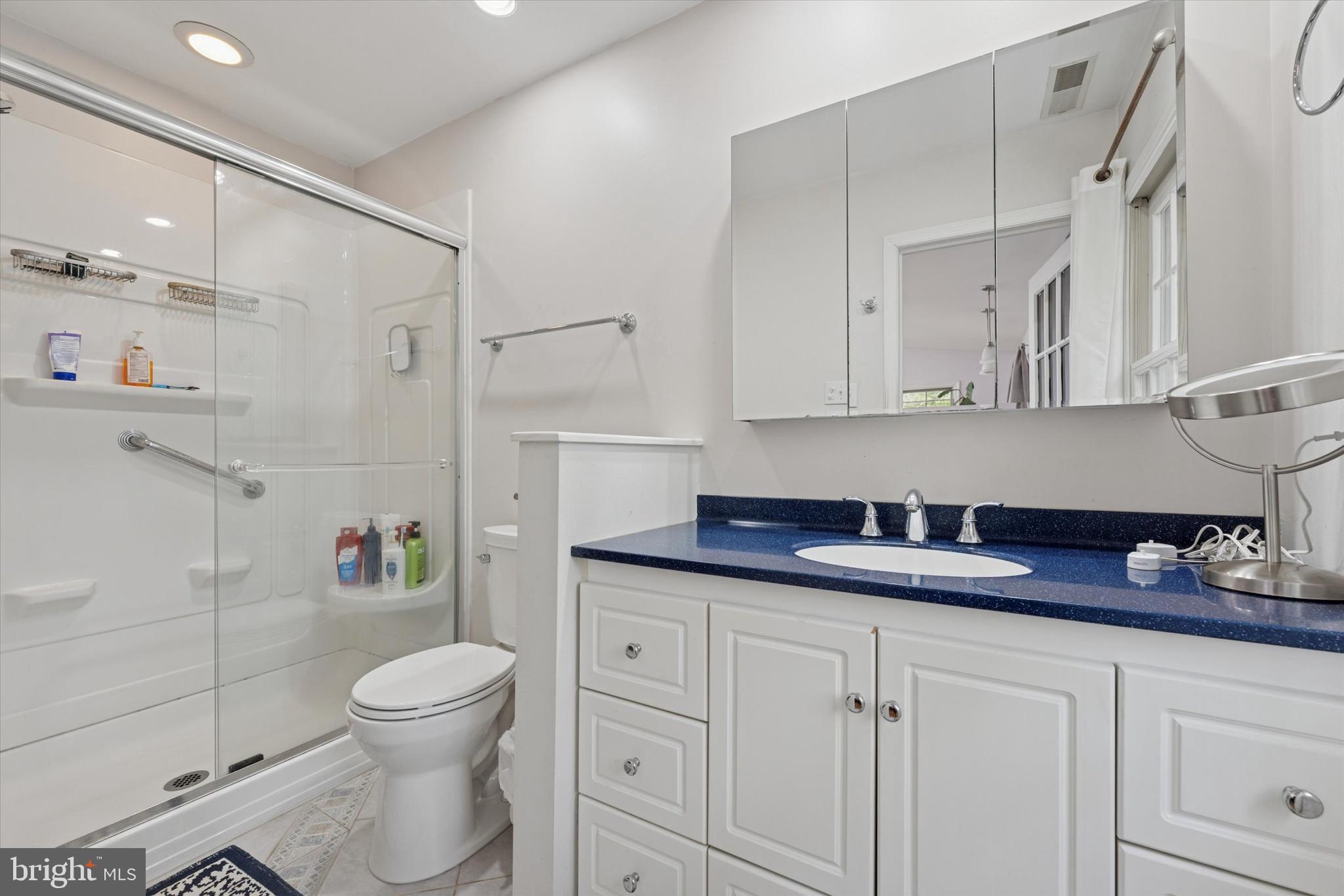 808 Berwyn Baptist Road Devon, PA 19333 - Photo 16 of 26 a bathroom with a granite countertop sink a toilet and shower