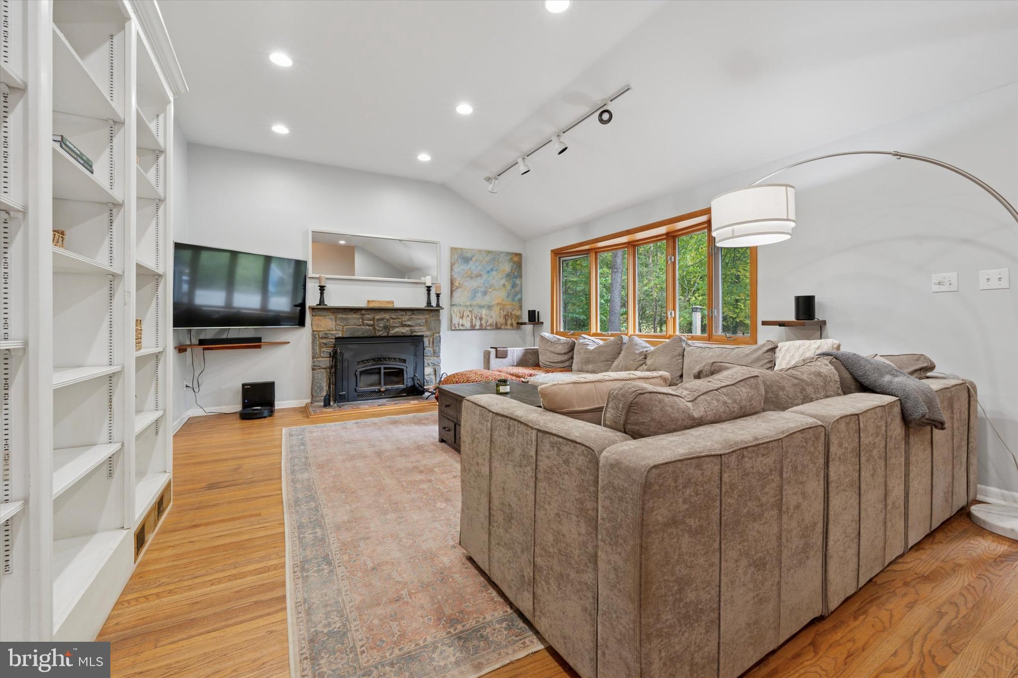 808 Berwyn Baptist Road Devon, PA 19333 - Photo 3 of 26 a living room with furniture a fireplace and a flat screen tv