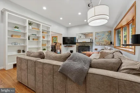 a living room with furniture fireplace and flat screen tv