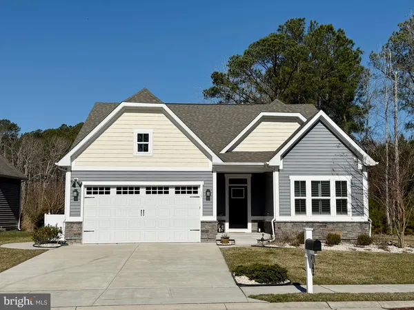 a front view of a house with garage
