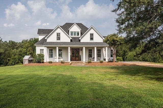 1117 Tyus-Veal Road Bowdon, GA 30108 - Photo 1 of 1 a front view of a house with a garden