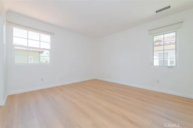an empty room with windows and closet