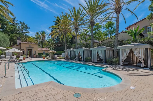 a view of a patio with a table and chairs under an umbrella
