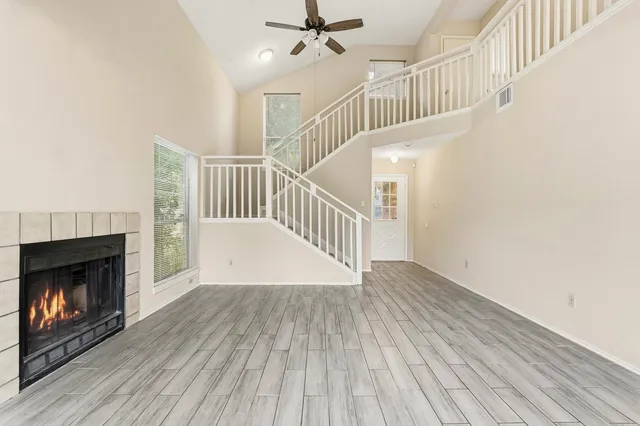 a view of livingroom with wooden floor and a fireplace