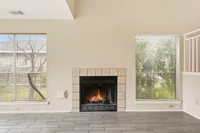 a living room with fireplace and a window