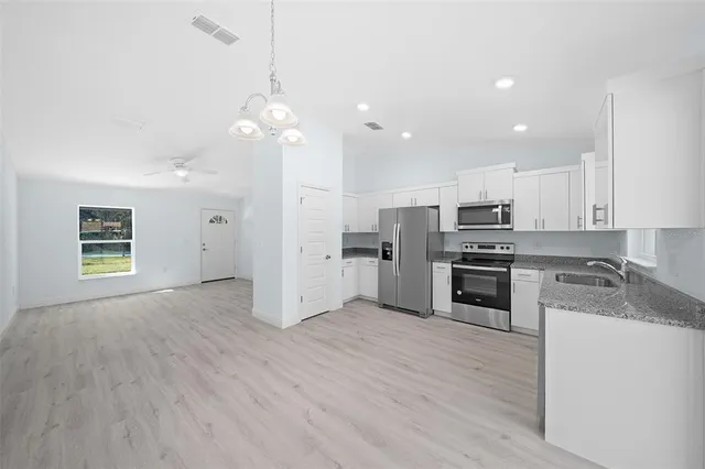 a kitchen with stainless steel appliances a refrigerator sink and stove