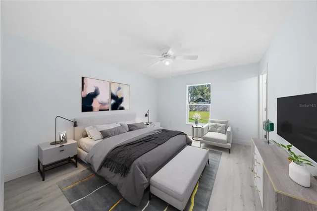 a bedroom with a bed and a flat screen tv