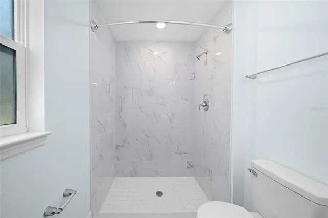 a bathroom with a shower and a toilet