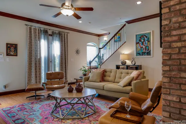 a living room with furniture and wooden floor