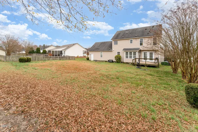a big house with a big yard and large trees