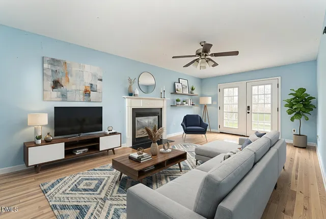 a living room with furniture a fireplace and a flat screen tv