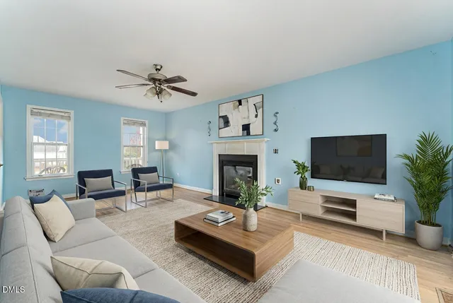 a dining room with furniture a chandelier and wooden floor
