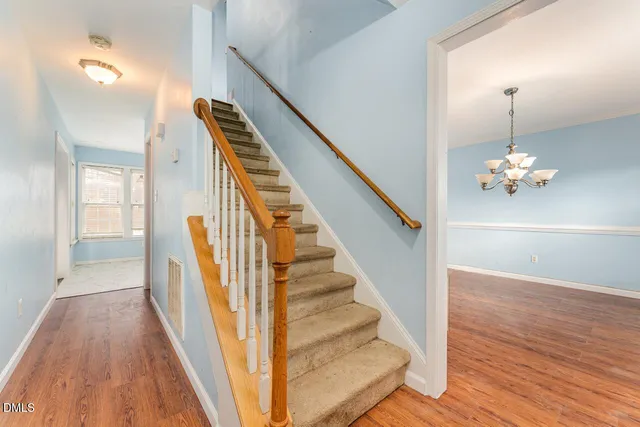a kitchen with granite countertop white cabinets stainless steel appliances and a sink