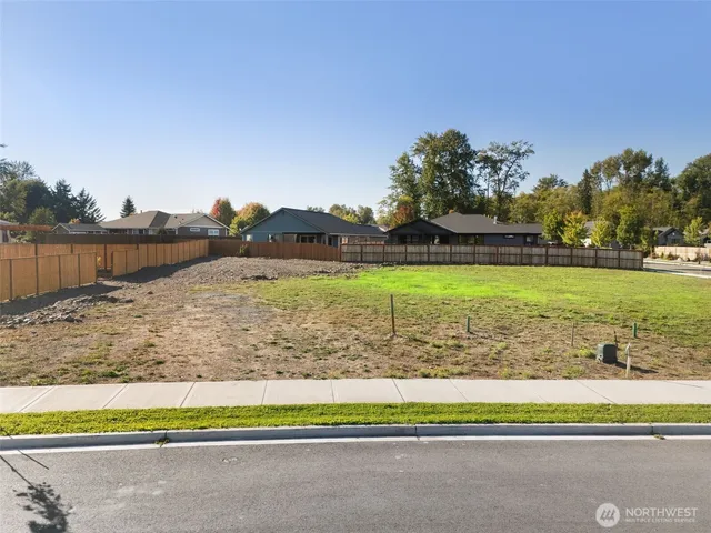 a view of a lake with a big yard and large trees