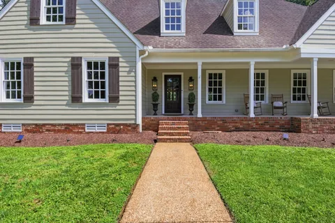 a front view of a house with a yard and porch