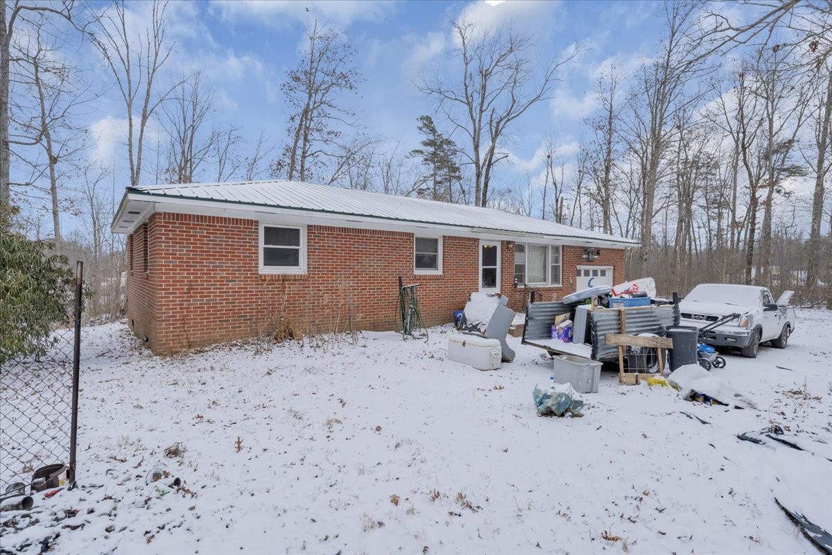646 Main Street Altamont, TN 37301 - Photo 30 of 39 a backyard of a house with lawn chairs and wooden fence