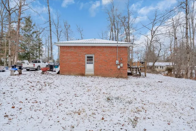 a view of a lounge chair and table in the backyard