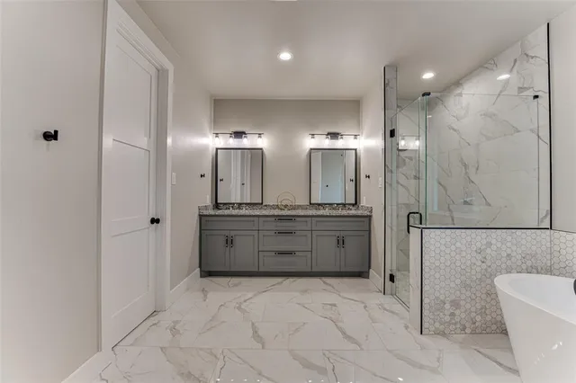 a bathroom with a granite countertop sink mirror and shower