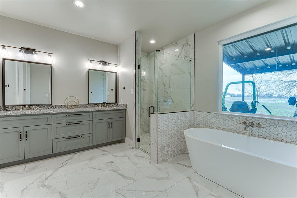 3167 County Road 1076 Celeste, TX 75423 - Photo 20 of 26 a spacious bathroom with a granite countertop sink a toilet a mirror and shower