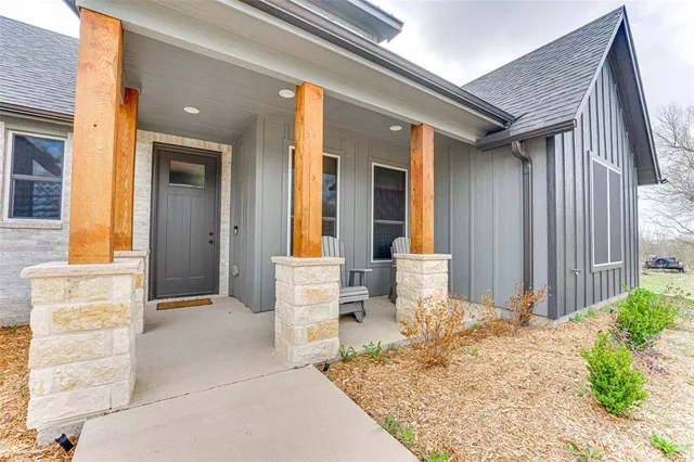 a front view of a house with outdoor seating