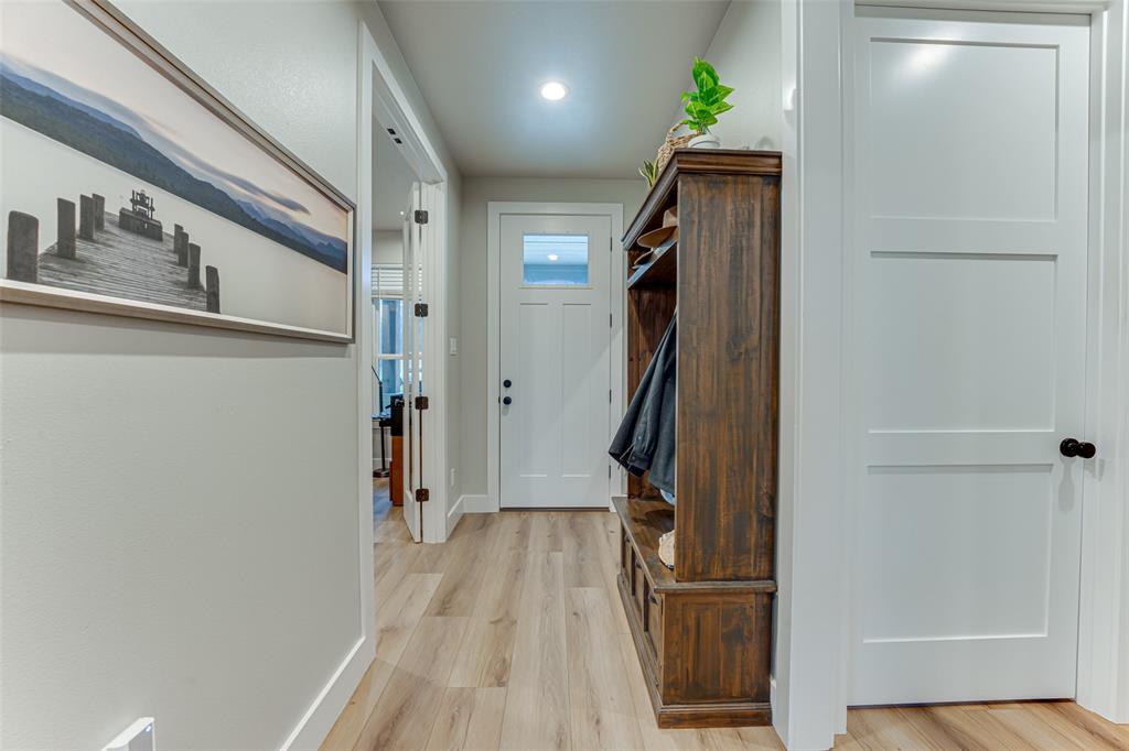 3167 County Road 1076 Celeste, TX 75423 - Photo 4 of 26 a view of a hallway with wooden floor and staircase