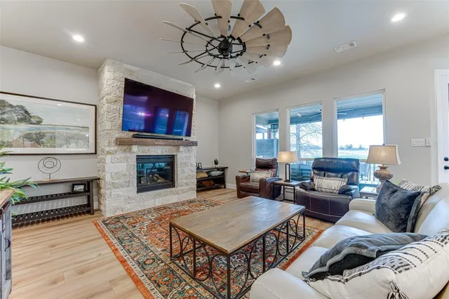 a living room with furniture a fireplace and a flat screen tv