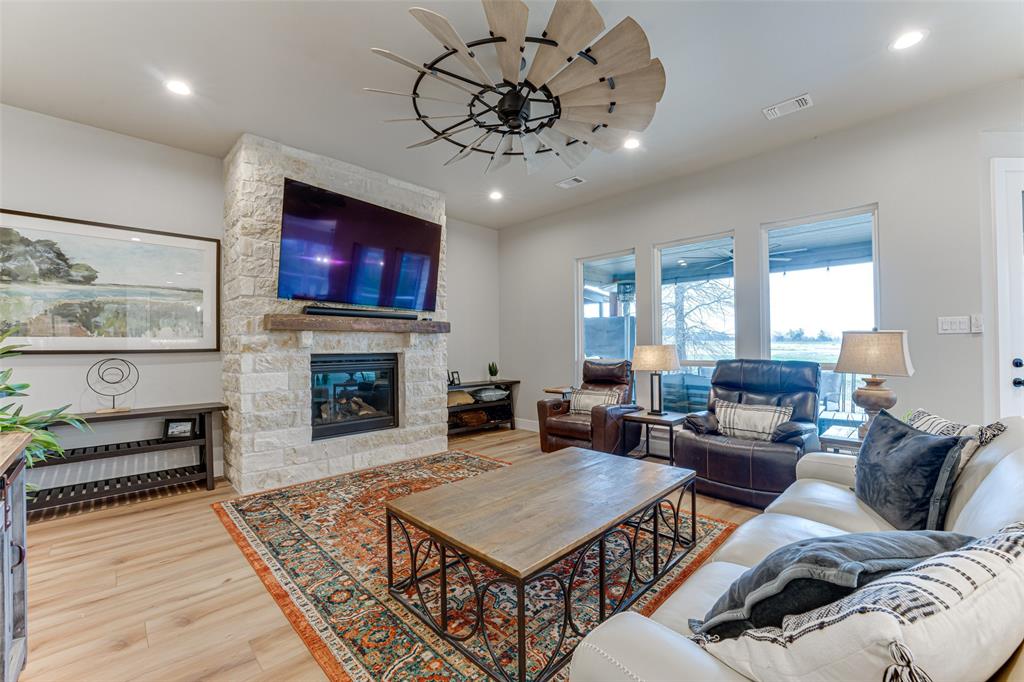 3167 County Road 1076 Celeste, TX 75423 - Photo 5 of 26 a living room with furniture a fireplace and a flat screen tv