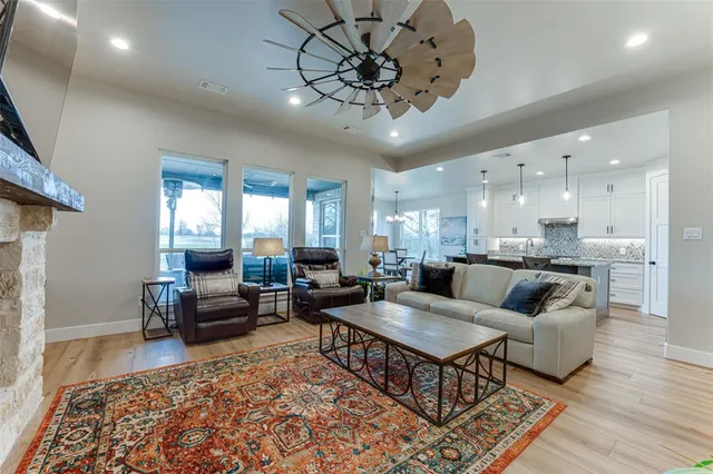a living room with furniture and a chandelier