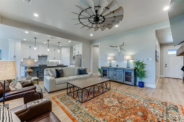 a living room with furniture and a chandelier