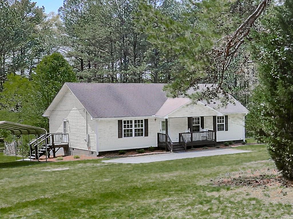 900 Everett Springs Road Southwest Calhoun, GA 30701 - Photo 1 of 1 a house view with a garden space