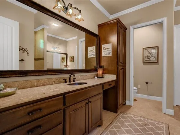a bedroom with a bed ceiling fan and window
