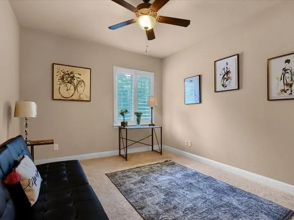 a bathroom with a granite countertop sink toilet and mirror