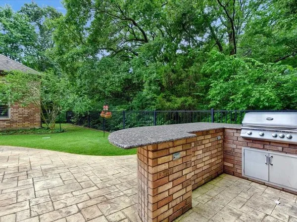 a outdoor space with patio the couches and a fireplace with the potted plants