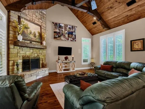 a living room with furniture fireplace and flat screen tv