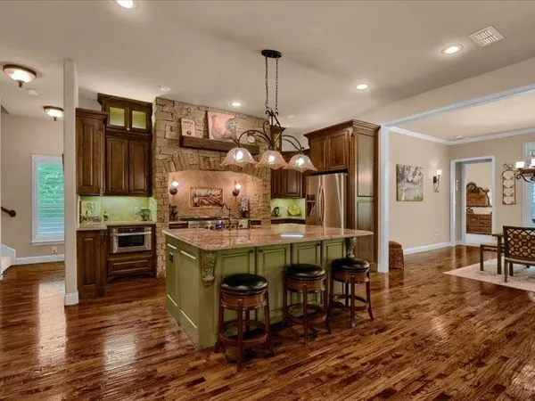 a kitchen with stainless steel appliances granite countertop a stove oven and a refrigerator