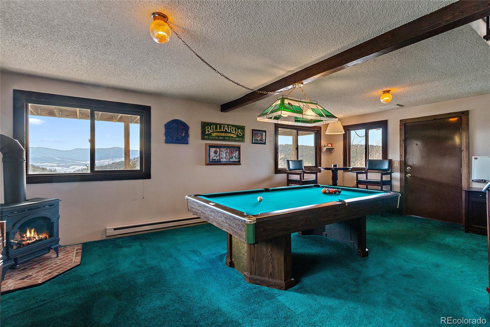 13976 Wamblee Trail Conifer, CO 80433 - Photo 22 of 39 a room with pool table and windows
