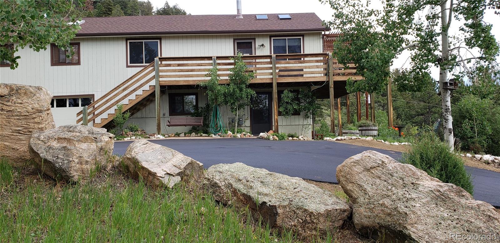 13976 Wamblee Trail Conifer, CO 80433 - Photo 38 of 39 a front view of a house with garden