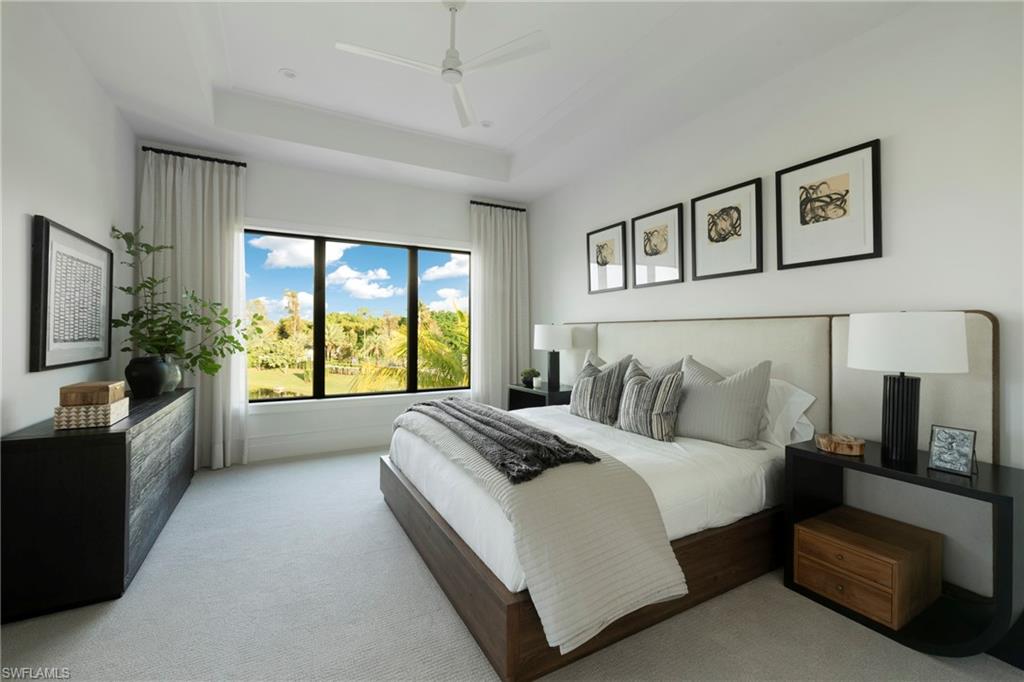 6704 Newport Road Naples, FL 34109 - Photo 25 of 47 a spacious bedroom with a large bed and a couch